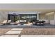 Stylish covered outdoor patio with seating, dining, and views of the backyard and pool at 4135 N Durango Dr, Las Vegas, NV 89129