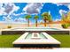 A stunning pool and fire pit area surrounded by artificial turf and palm trees at 4135 N Durango Dr, Las Vegas, NV 89129