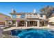 A stunning backyard featuring a sparkling pool, covered patio, and beautifully landscaped surroundings, perfect for relaxation and entertainment at 4339 Grey Spencer Dr, Las Vegas, NV 89141