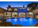 An inviting backyard featuring a sparkling pool, covered patio, and lush landscaping perfect for outdoor living at 4339 Grey Spencer Dr, Las Vegas, NV 89141