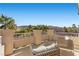 Relaxing balcony with outdoor seating, offering scenic views of palm trees and neighboring houses at 4339 Grey Spencer Dr, Las Vegas, NV 89141