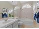 Cozy bathroom featuring a bathtub, vanity with sink, and arched window allowing natural light at 4339 Grey Spencer Dr, Las Vegas, NV 89141