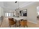 Stylish dining room with a modern light fixture, sleek table, and artistic decor creating an inviting atmosphere at 4339 Grey Spencer Dr, Las Vegas, NV 89141