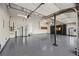 Clean garage with epoxy flooring, custom cabinets, storage shelves, and overhead lighting for vehicles and projects at 4339 Grey Spencer Dr, Las Vegas, NV 89141