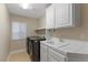 Functional laundry room with a sink, counter space, washer, dryer, and ample storage cabinets at 4339 Grey Spencer Dr, Las Vegas, NV 89141
