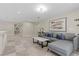Comfortable upstairs living room with a gray sectional sofa, modern coffee table, and stylish decor at 4339 Grey Spencer Dr, Las Vegas, NV 89141