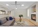 Comfortable living room with plush seating, modern lighting, and corner fireplace at 4339 Grey Spencer Dr, Las Vegas, NV 89141