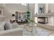 Open living room featuring fireplace, neutral furniture and many windows at 4339 Grey Spencer Dr, Las Vegas, NV 89141