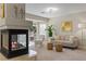 Comfortable living room featuring a fireplace, modern furniture, and access to a balcony with greenery at 4339 Grey Spencer Dr, Las Vegas, NV 89141
