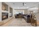 Comfortable living room with a fireplace, plush seating, and a view of the backyard through large windows at 4339 Grey Spencer Dr, Las Vegas, NV 89141