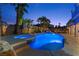 Inviting backyard pool and spa area with mature palm trees and cool blue lighting at twilight at 4339 Grey Spencer Dr, Las Vegas, NV 89141