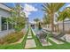Lush backyard showcasing a sparkling pool, comfortable lounge chairs, and meticulous landscaping with palm trees at 4345 N Dapple Gray Rd, Las Vegas, NV 89129