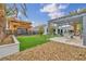 Spacious backyard featuring a covered patio, lush landscaping, and stone accents, ideal for outdoor entertaining at 4345 N Dapple Gray Rd, Las Vegas, NV 89129