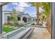 Resort-style backyard with a modern fire pit, lounge chairs, and lush landscaping creating a private oasis at 4345 N Dapple Gray Rd, Las Vegas, NV 89129