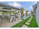 Serene backyard with manicured grass, pool, spa, and outdoor kitchen creating an ideal entertainment and relaxation space at 4345 N Dapple Gray Rd, Las Vegas, NV 89129