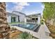 Backyard features a pool, spa, and outdoor kitchen, blending entertainment with desert landscaping at 4345 N Dapple Gray Rd, Las Vegas, NV 89129