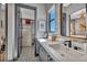 Contemporary bathroom with dual sinks, modern hardware, and access to a walk-in closet at 4345 N Dapple Gray Rd, Las Vegas, NV 89129