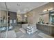 Bright bathroom featuring a large tub, dual sinks, wooden cabinets and walk-in shower at 4345 N Dapple Gray Rd, Las Vegas, NV 89129