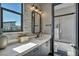 Bright bathroom with geometric tiled floors, modern vanity, and marble-walled shower at 4345 N Dapple Gray Rd, Las Vegas, NV 89129