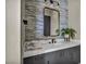 Bright and modern bathroom with vanity, mirror, tiled accent wall, and modern fixtures at 4345 N Dapple Gray Rd, Las Vegas, NV 89129