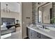 Modern bathroom offers a gray vanity with a sink, a mirror, and bedroom access at 4345 N Dapple Gray Rd, Las Vegas, NV 89129