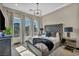 This luxury bedroom has large windows, designer lighting, and a tufted headboard at 4345 N Dapple Gray Rd, Las Vegas, NV 89129