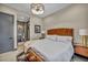 Bedroom featuring a stylish wood bed frame, a modern light fixture, and an ensuite bathroom at 4345 N Dapple Gray Rd, Las Vegas, NV 89129