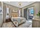 Modern bedroom features a gray color scheme, ensuite bathroom, and stylish light fixture at 4345 N Dapple Gray Rd, Las Vegas, NV 89129