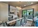 Dining room showcases a contemporary chandelier and access to the outdoor area and kitchen at 4345 N Dapple Gray Rd, Las Vegas, NV 89129