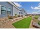 The front yard showcases stone accents, green turf, and drought-tolerant landscaping, creating an inviting exterior at 4345 N Dapple Gray Rd, Las Vegas, NV 89129
