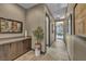 Hallway with neutral walls and a console with a plant, leading to a room in the background at 4345 N Dapple Gray Rd, Las Vegas, NV 89129
