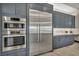 Stainless steel refrigerator and double ovens with custom cabinets and countertops at 4345 N Dapple Gray Rd, Las Vegas, NV 89129