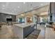 Open concept kitchen with island and stainless steel appliances with views to living and dining at 4345 N Dapple Gray Rd, Las Vegas, NV 89129
