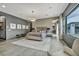Comfortable main bedroom features stylish chandelier, seating area and gray and neutral color scheme at 4345 N Dapple Gray Rd, Las Vegas, NV 89129