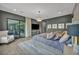 Comfortable main bedroom features large sliding glass door, stylish chandelier, and an entertainment center at 4345 N Dapple Gray Rd, Las Vegas, NV 89129