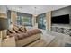 Comfortable main bedroom features large window, stylish chandelier, and an entertainment center at 4345 N Dapple Gray Rd, Las Vegas, NV 89129