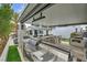 Spacious outdoor kitchen, featuring marble countertops, stainless steel appliances, and bar seating with outdoor entertainment at 4345 N Dapple Gray Rd, Las Vegas, NV 89129
