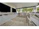 Well-equipped outdoor kitchen with stainless steel appliances, marble counters, bar seating, and media, perfect for outdoor cooking at 4345 N Dapple Gray Rd, Las Vegas, NV 89129