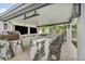 Luxurious outdoor kitchen with marble counters, bar seating, stainless steel appliances, and dual TVs for entertainment at 4345 N Dapple Gray Rd, Las Vegas, NV 89129