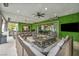 Spacious covered patio with ample seating, a large screen TV, an outdoor kitchen, and modern decor for ultimate relaxation at 4345 N Dapple Gray Rd, Las Vegas, NV 89129
