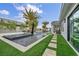 Backyard featuring a pool and spa, turf, and a covered patio, designed for relaxation and entertainment at 4345 N Dapple Gray Rd, Las Vegas, NV 89129