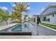 Stunning pool with mosaic tile and water feature, surrounded by lush landscaping, perfect for outdoor entertaining at 4345 N Dapple Gray Rd, Las Vegas, NV 89129