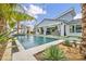 Backyard pool with tropical landscaping, offering a private retreat with a view of the home's modern architecture at 4345 N Dapple Gray Rd, Las Vegas, NV 89129