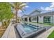 Inviting backyard with a pool and spa, blending seamlessly with the home's design and lush tropical landscaping at 4345 N Dapple Gray Rd, Las Vegas, NV 89129