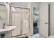 Bathroom with a walk-in shower and a pedestal sink, enhanced by neutral tones at 4350 Bossart Ct, Las Vegas, NV 89102