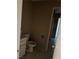 Modest bathroom with white toilet and vanity, set against neutral wall and tile flooring at 4442 Bennett Dr, Las Vegas, NV 89121