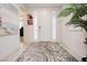 Inviting entryway with neutral tile flooring, decorative rug and contemporary front door at 4560 E Cactus Canyon Dr, Pahrump, NV 89061
