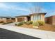 Single story home with desert landscaping including a decorative tree and rock ground covering at 4560 E Cactus Canyon Dr, Pahrump, NV 89061