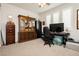 Well-lit home office space with an executive desk, storage, and decoratively appointed display cabinet at 4560 E Cactus Canyon Dr, Pahrump, NV 89061