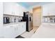 Bright kitchen with white cabinets, stainless steel appliances, and a tiled backsplash at 4560 E Cactus Canyon Dr, Pahrump, NV 89061